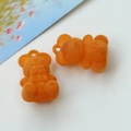 Macro detail of orange flocked bear charms for DIY jewelry and phone case accessories - Orange