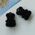 Macro detail of black flocked bear charms with integrated hanging holes for DIY jewelry making - Black