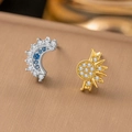 Macro detail of sun and moon asymmetric stud earrings with sparkling blue and white crystals - Copper / Sun and Moon Earrings (G302)