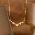 Close-up of golden laurel leaf pendant necklace with shimmering zircon stones and fine chain - Simple Arc Flower Cluster (9171)