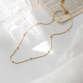 Elegant gold bead necklace with fine chain displayed on a vintage white background - 45cm+5cm / Gold