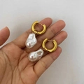 Baroque pearl earrings with golden hoops and irregular white pearls held in hand - Broad Bean Artificial Pearl Style (G143) / Gold