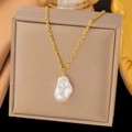 Elegant gold twisted chain necklace featuring a large white baroque pearl pendant - Irregular Pearl (H365) / Gold