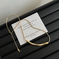 Close-up of golden irregular tube pendant on snake chain over elegant display card - Crinkled Tube Style (H613) / Gold