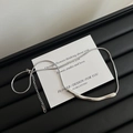 Irregular silver stainless steel snake chain necklace with curved pendant on black background - Crinkled Tube Style (H666) / Silver