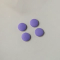 Close-up of four round purple fabric-covered buttons with fine twill texture for DIY - Lavender
