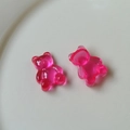 Detail macro view of translucent jelly gummy bear charms in vibrant pink resin - Rose Red