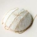 Elegant gold plated O-shaped fine link chain draped over white coral decor for jewelry - Gold