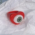 Detailed view of red heart-shaped resin ring featuring a realistic green doll eye focal point - Red