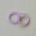 Minimalist summer style translucent purple resin rings set on white stone surface - Amethyst