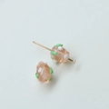 Macro shot of two handmade glass beads in pink with white dots and green accents - Strawberry Style (35#) / 1 Piece / Pink