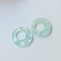 Close-up of mint green marble resin ring pendants with iridescent finish for DIY jewelry - Mint Green