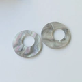 Macro shot of circular marble texture resin charms for DIY jewelry and earrings - Grey Purple