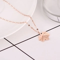 Minimalist maple leaf pendant necklace in rose gold stainless steel on ceramic plate - Rose Gold