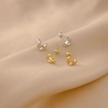Detail of moon-shaped titanium steel stud earrings with cubic zirconia on silk cloth - Rhinestone Moon Spiral Stud / Gold