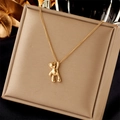 Minimalist 3D bear pendant necklace in polished gold finish on a luxury jewelry tray - Vintage Simple Bear (N2026)