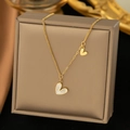 Golden heart necklace with white mother-of-pearl inlay and asymmetrical chain design - Big Small Heart Shell