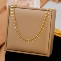 Minimalistische Goldkette mit quadratischen Quastenanhängern auf Seidenhintergrund - Y-Halskette (Gold)
