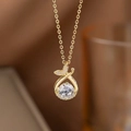Elegant gold bow necklace with round clear crystal and pink zircon accents - Gold