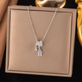 Silver-tone necklace featuring blue enamel rings and pink gemstone pendant on a display box - Geometric Pink Diamond Style (8288)