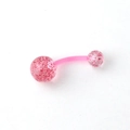 Macro shot of curved acrylic belly ring with pink glitter-filled transparent balls - Pink