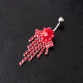 Silver flower belly ring with red crystals and dangling tassels on black leather background - Red