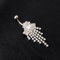 Close-up of silver tassel belly button ring with rhinestones on black leather - White