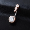 Close-up of rose gold belly ring featuring brilliant zircons on black leather texture - Rose Gold
