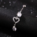 Detailed macro view of silver belly ring with hollow heart and pear-shaped zircon stone - Hollow Heart Water Drop / Heart White