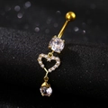 Macro detail of golden heart belly ring with clear cubic zirconia teardrop pendant - Hollow Heart Water Drop / Heart Gold