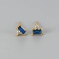 Detail of gold studs featuring rectangular blue gemstone and round white zircon - Royal Blue Zirconia Gold