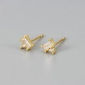 Macro shot of rectangular zircon stud earrings with 18K gold plating and claw setting - White Zirconia Gold Color