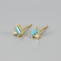 Macro detail of gold-plated earrings featuring rectangular blue stone and zircon studs - Blue Turquoise Gold