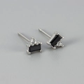 Detail of silver stud earrings featuring rectangular black gemstone and zircon accents - Black Zirconia Silver