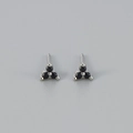 Close-up of minimalist silver stud earrings featuring three black round-cut stones - Black Stone Silver Base