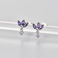 Macro shot of S925 silver stud earrings with marquise-cut purple gems on a display - Silver/Purple