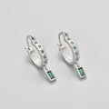 Detail of silver hoop earrings with emerald-cut green stone and star engravings - Platinum/Green Zirconia