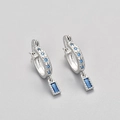 Detailed view of silver hoop earrings featuring rectangular and round blue zircons - Platinum Color/Blue Zirconia