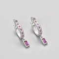 Detailed macro shot of silver hoop earrings with star carving and pink zircon pendants - White Gold / Rose Red Zirconia