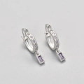 Detail view of silver hoop earrings featuring star patterns and purple zircon drop charms - Platinum/Purple Zirconia