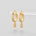 Detail of gold huggie earrings with star engraving and rectangular cubic zirconia pendant - Gold/White Zirconia