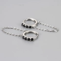 Close-up of silver chain earrings featuring five round-cut black cubic zirconia stones - Chain Hoop Earring / Platinum/Black
