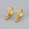 Close-up of gold butterfly earrings with champagne zircon stones on grey background - Gold / Champagne Zirconia