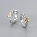 Macro shot of silver S925 earrings with square yellow gemstone and micro-pave zircons - Platinum / Champagne Zirconia