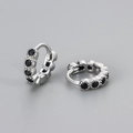 Macro shot of silver hoop earrings with a line of sparkling black zircon stones - Medium Silver Black Zirconia Style