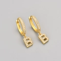 Detailed view of gold hoop earrings with sparkling zircon micro-pave and letter B pendant - Gold / B