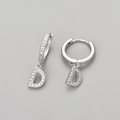 Close-up of letter D hoop earrings in silver finish with pavé set white zircon stones - Silver / D