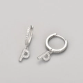 Macro shot of silver letter P hoop earrings featuring micro-pave cubic zirconia stones - Silver / P