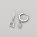 Detail view of silver earrings featuring micro-pave letter Q pendants with shiny cubic zirconia - Silver / Q