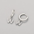 Macro shot of silver letter W earrings with micro-paved cubic zirconia on grey backdrop - Silver / W